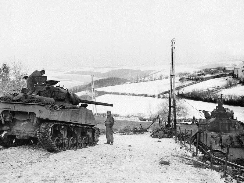 In this January, 1945 photo US tank crews wait in the snow during the Battle of the Bulge.