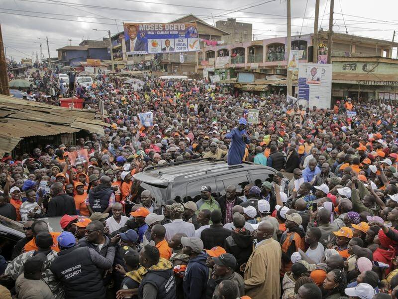 Kenyan presidential candidate Raila Odinga waves to supporters during a campaign rally in Nairobi. (AP PHOTO)