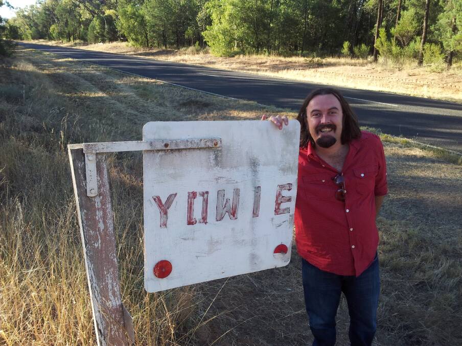 Dane Millerd at the Yowie sign in the Pilliga. The former Blaxland boy has produced There's Something In The Pilliga. Photo: Stefan Smith.