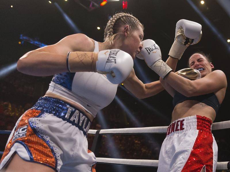 Tayla Harris connects with a left to Renee Gartner during their middleweight bout.