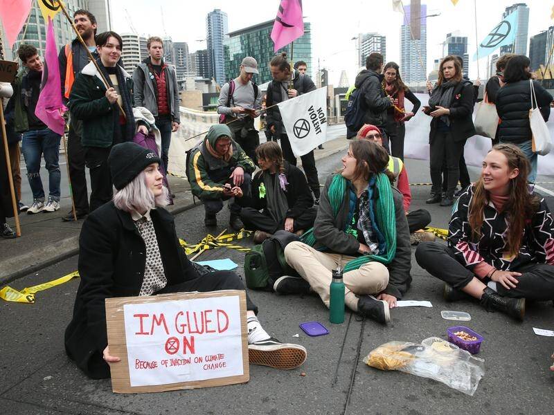 Climate activists have blocked traffic in Melbourne by gluing themselves to the road.