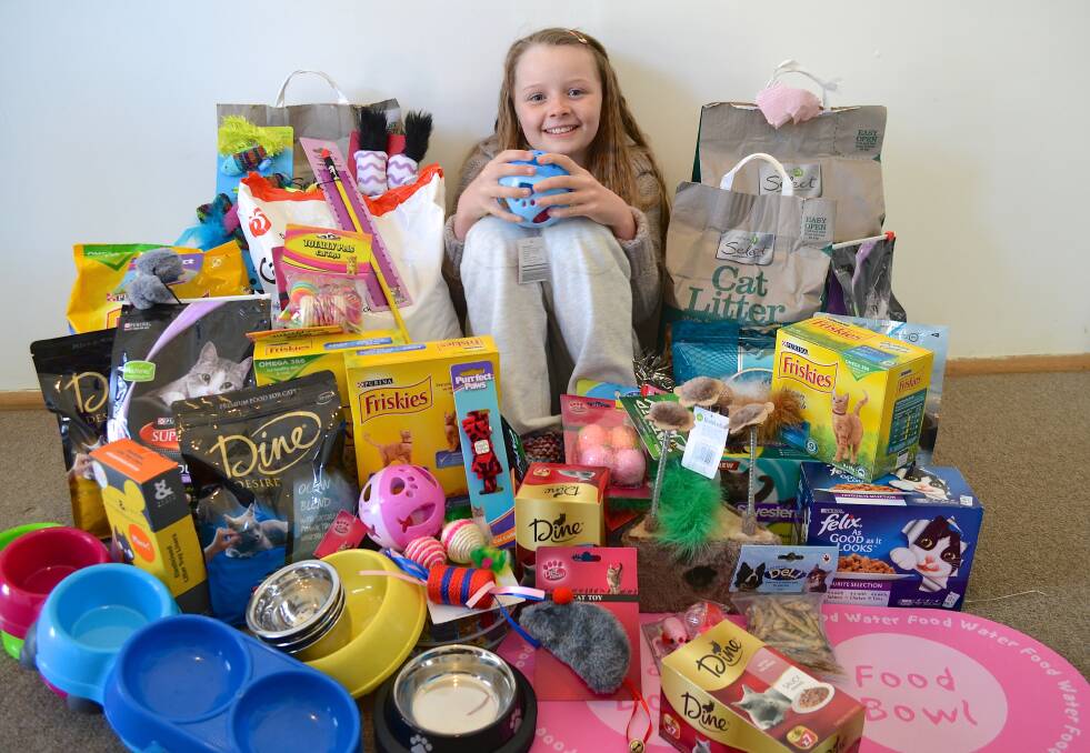 Ten-year-old Faulconbridge birthday girl Jemima Addison with her pile of requested presents of all sorts of cat goodies. She donated them all last Thursday to Katoomba-based organisation Rescue Cat Adoptions.
