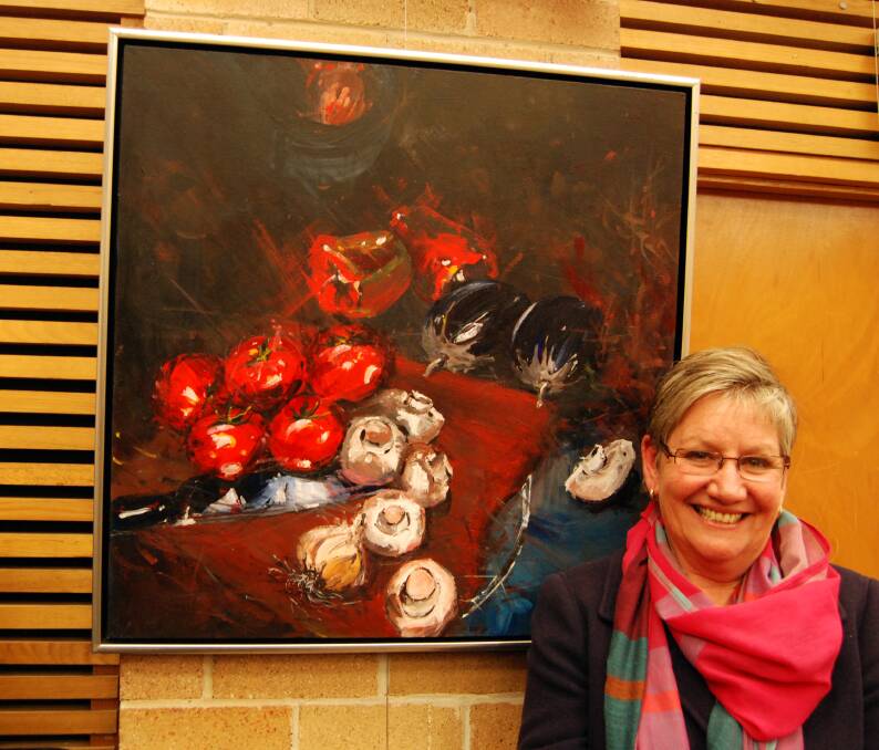 Big winner: Julie Simmons from Castlereagh next to her painting Big Reds, which won the major award at the 2014 Springwood Art Show last Friday night.