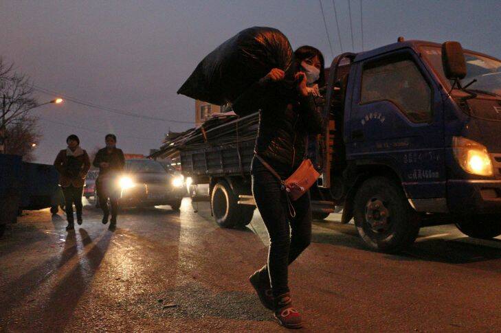Zhou Xiaomei, 44, a house cleaner in Beijing moves her living goods at Picun Village on November 27, 2017 .