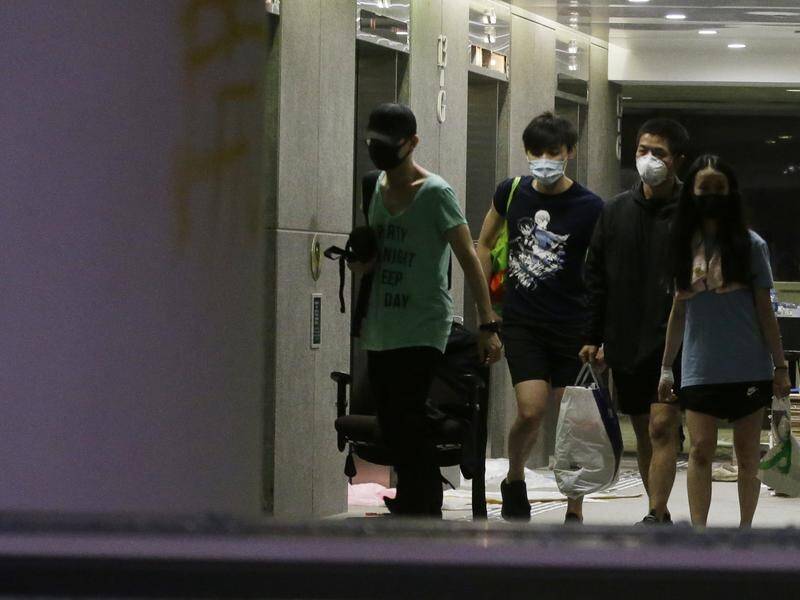 A handful of protesters remain in a Hong Kong campus as police appear prepared to wait them out.
