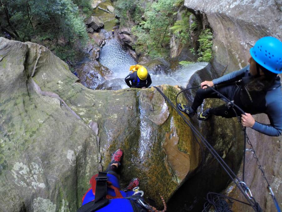 Nina and Simon abseil down a 30m waterfall in the Blue Mountains.