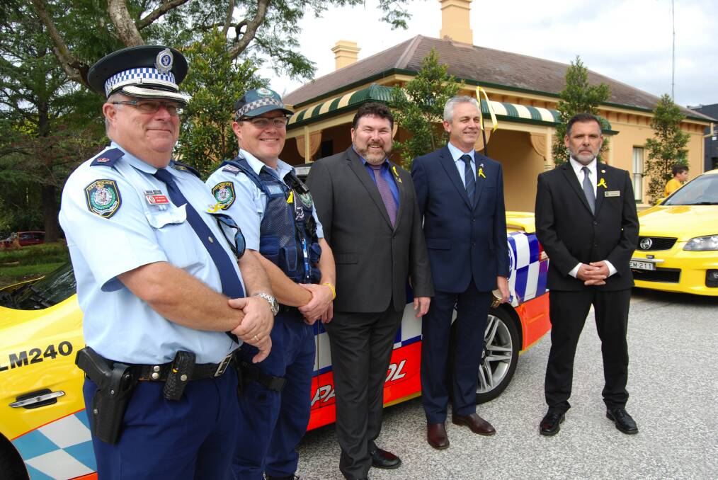 Chief Inspector Mark Cook, Snr Constable Brad Cooper, SARAH's Peter Frazer, the Police Association's Mick Hilder and Serge Rosato beside one of the many emergency services vehicles on display on the day.