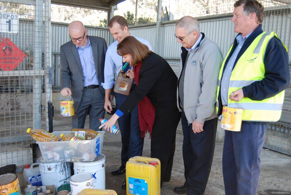 Mayor Mark Greenhill, NSW Environment Minister, Rob Stokes, Blue Mountains MP Roza Sage, Clr Cri Van der Kley and Stephen Hill, site co-ordinator at Katoomba Waste Management Facility look at some of the bottles of cooking oils delivered to the tip hidden in other waste.