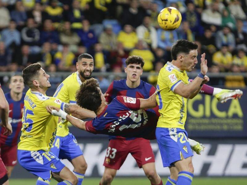 Joao Felix (centre) launches himself to score for Barcelona in their 1-0 win at Cadiz. (EPA PHOTO)