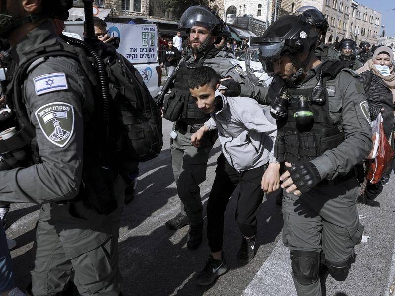 Israeli police detain a Palestinian youth following confrontations in Jerusalem's Old City.
