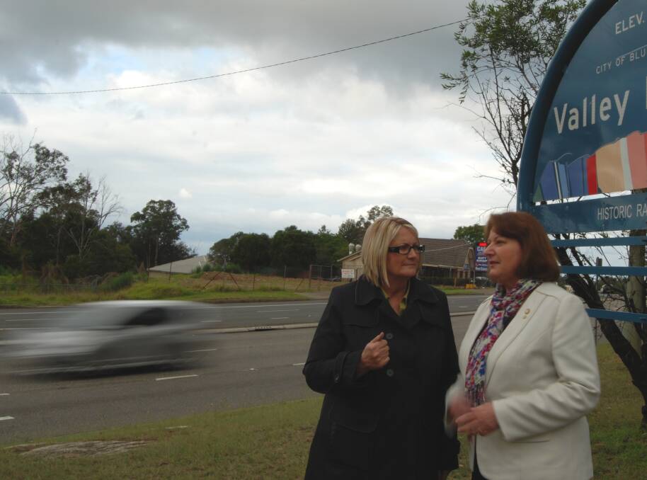 Member for Macquarie Louise Markus and Blue Mountains MP Roza Sage at the intersection of the highway and Macquarie Road in Springwood last Friday, which will benefit from a $640,000 National Black Spot Program safety upgrade.