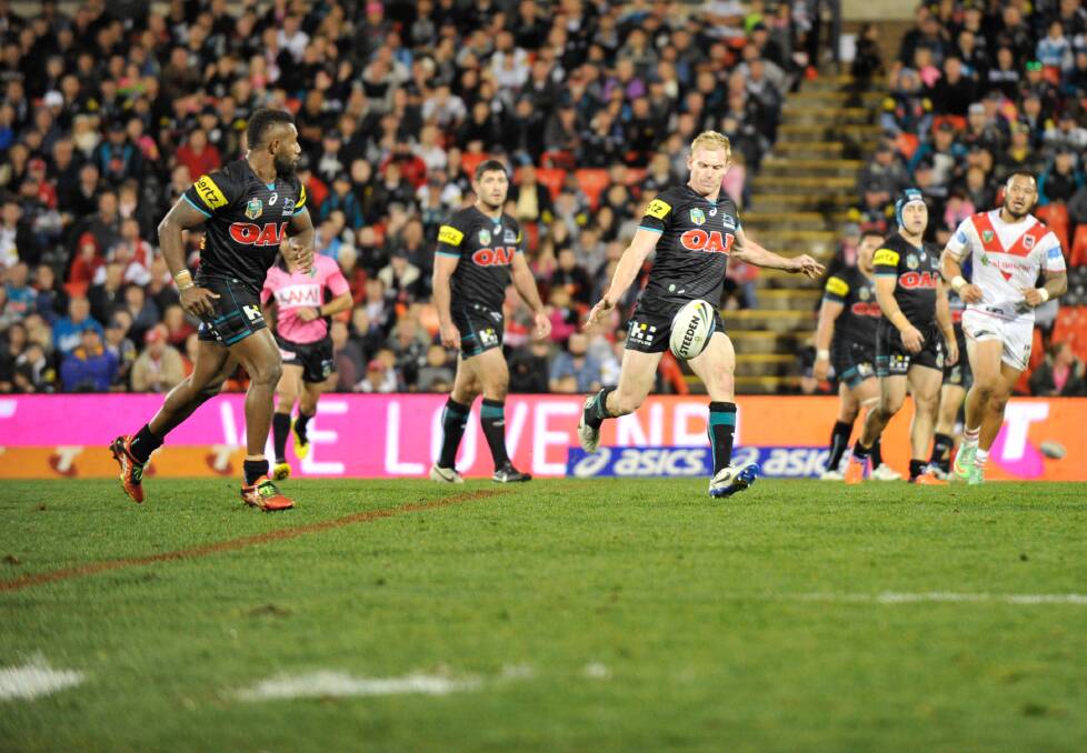 Penrith halfback Peter Wallace prepares to kick during the Panthers' win against the Dragons on June 14.