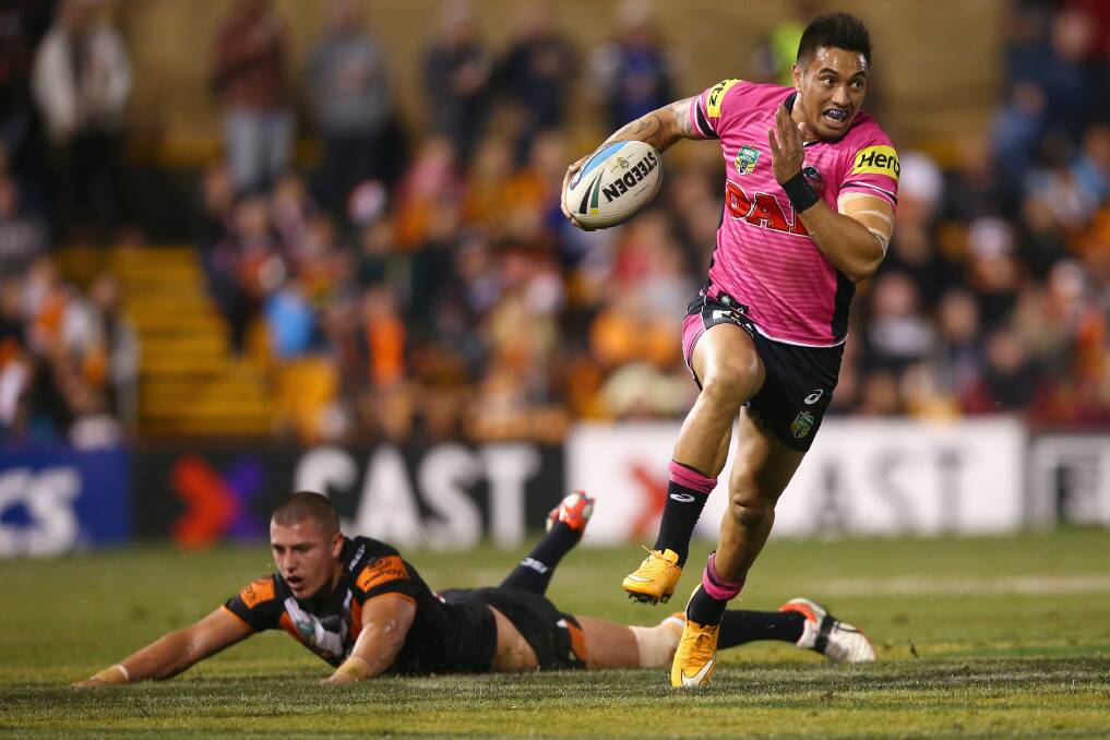 Footwork:  Dean Whare of the Panthers evades the tackle of Kyle Lovett of the Wests Tigers during the round 16 NRL match between the Wests Tigers and the Penrith Panthers at Leichhardt Oval. (Photo by Mark Kolbe/Getty Images)