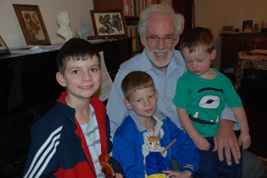 Music teacher Malcolm John Hewitt of Faulconbridge with his children Reginald, 8; Gordon, 5 and Jeremy, 3, celebrating the news of his honour in the Queen's Birthday list.