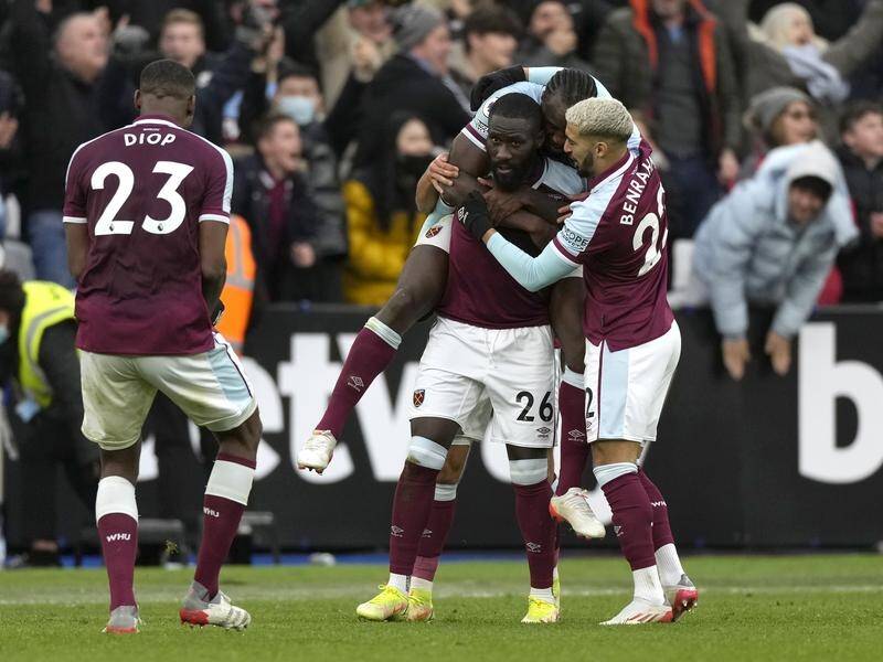 Arthur Masuaku is mobbed by teammates after scoring the winner for West Ham against Chelsea.