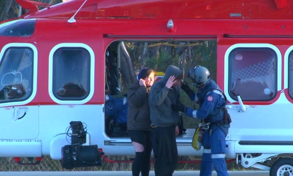 Safe and sound: Ambulance Helicopter SCAT paramedics assist two injured teenage hikers near Govetts Leap lookout on Monday morning. Photo: Top Notch.