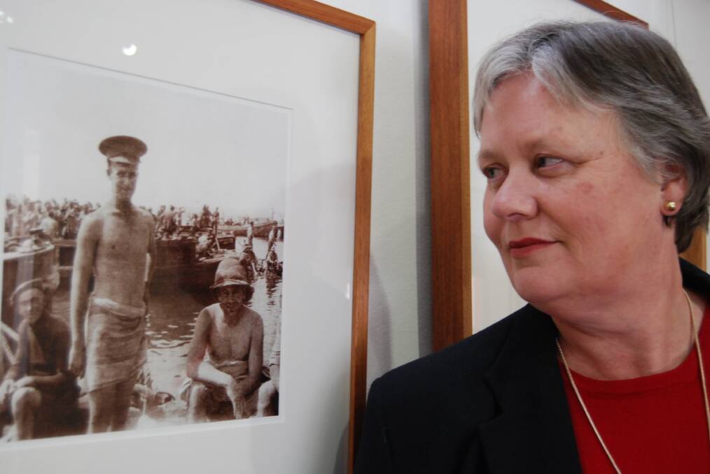Norman Lindsay's acting manager Gaye McKenna with one of Charles Ryan photographs, part of the War Memorial's exhibition at the gallery until September 15. Photo: Shane Desiatnik.