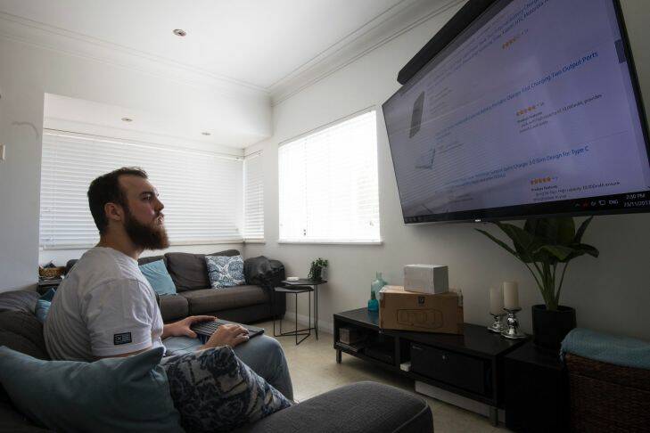 James Hall, Amazon buyer, at his Concord home. is a gym junkie who is big into tech and video games. He has a pretty good computer setup where he will buying his orders from. He is
planning to buy christmas presents for his mother. 23rd November 2017 photo by Louise Kennerley smh