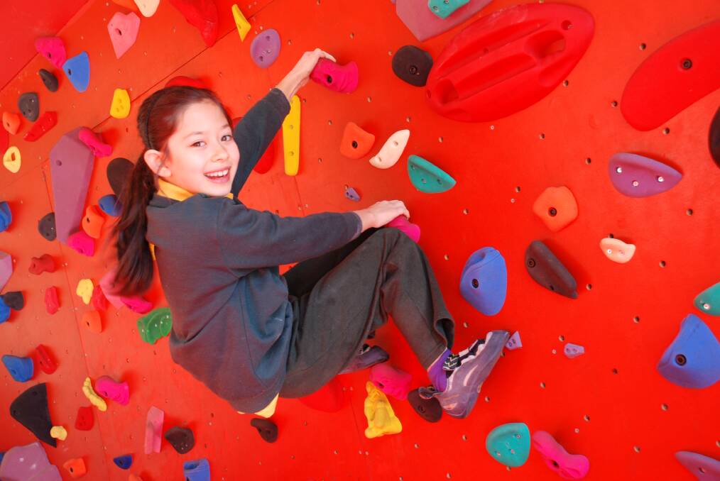 Tiny Blackheathen Angie Scarth-Johnson is a national and world champion. Pictured on Blackheath Public School's new climbing wall, which was built and paid for recently by the school's parents, under the guidance of local climber Adrian Lang.