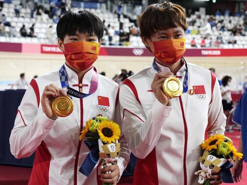 The IOC will query Chinese cyclists Zhong Tianshi and Bao Shanju for wearing a controversial pin.
