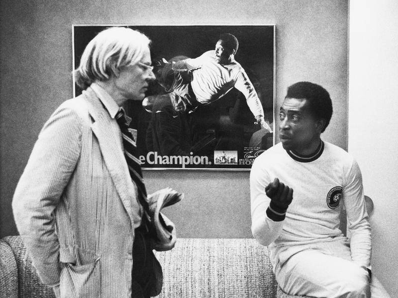 Andy Warhol, seen here with Pele in 1977, said the soccer star's fame would last 15 centuries. (AP PHOTO)