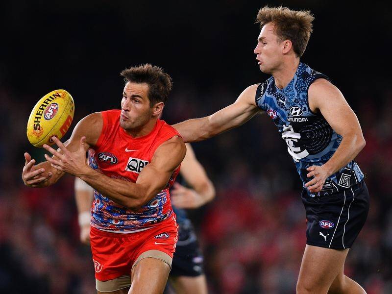 Sydney veteran Josh Kennedy (l) was charged and injured in the Swans' defeat to Carlton.