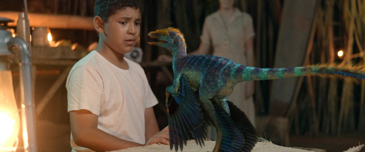 Blue Mountains Grammar School film star Darius Williams with a sinornithosaurus in Matt Drummond's debut feature film Dinosaur Island.
