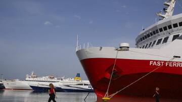 Ships stayed docked at Greek ports and train services were halted as workers protested rising costs. (AP PHOTO)