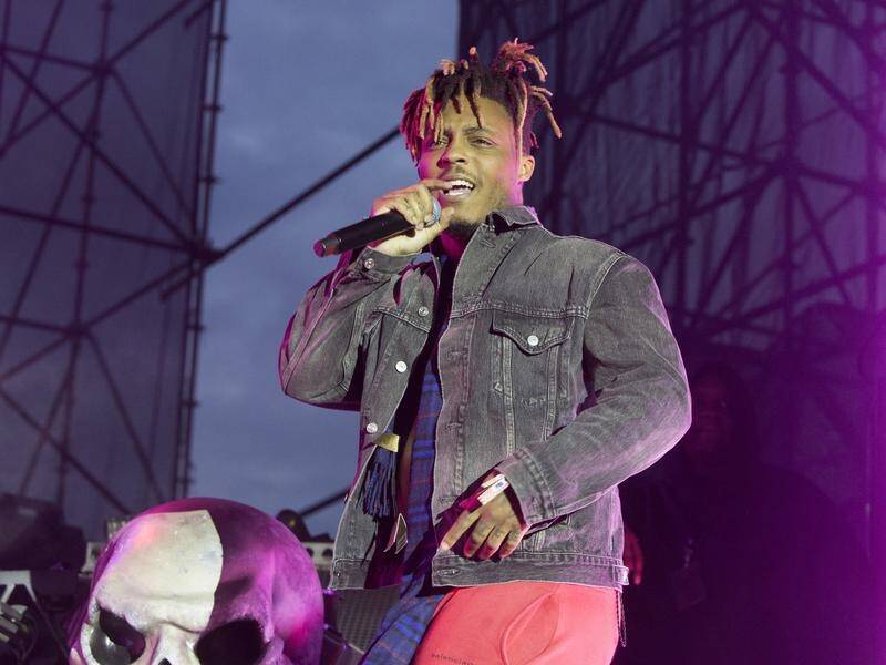 US rapper Juice WRLD has died after suffering a seizure while walking through an airport; he was 21.