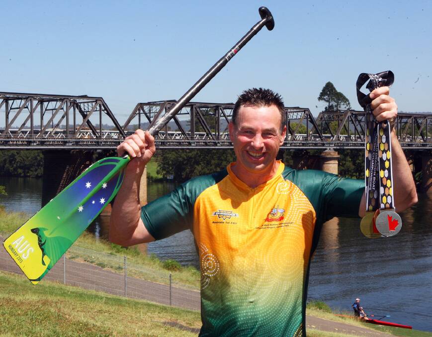 Gold, silver and bronze: Blaxland resident Peter Fox from Pendragons Club at Penrith won a gold a medal at the 2015 Dragon Boat World Championships held in Canada. He is pictured with his medals next to the Nepean River. Photo: Gary Warrick.