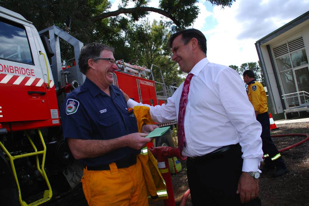  Principal Serge Rosato (right) shares a light moment before the ceremony with Faulconbridge brigade volunteer Vincent Hurley. Mr Rosato has repeatedly praised the actions of the emergency services who worked tirelessly on the day to save lives and property.