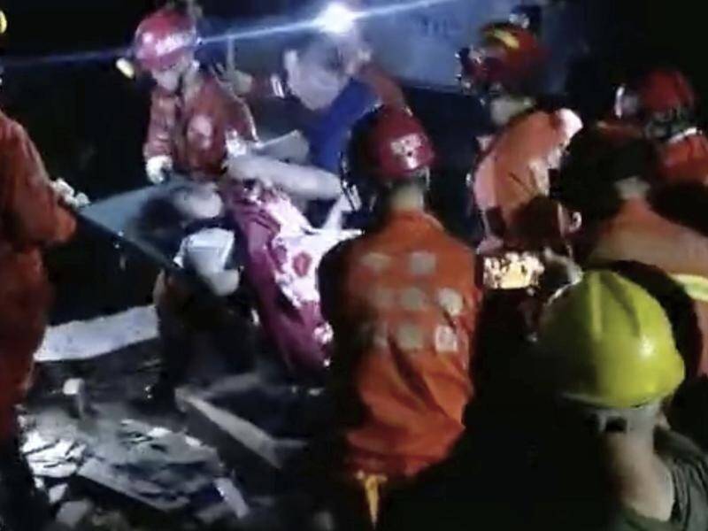Rescuers pull survivors from building rubble after two strong earthquakes in south west China.