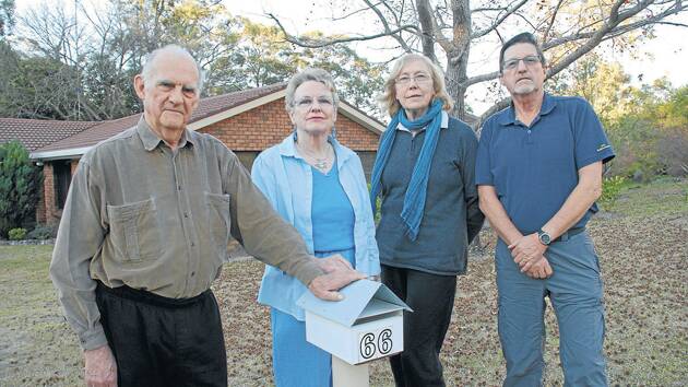 John and Joan McKay outside their new home in Springwood with their former Winmalee neighbours Jenny and Tony Foster.
