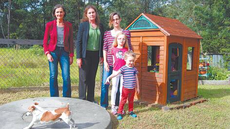 Clr Romola Hollywood and ALP candidate for the Mountains Trish Doyle with Linden student Donna Gummidge, her children Amelia and Max, and Gavin the dog on top of their septic tank.