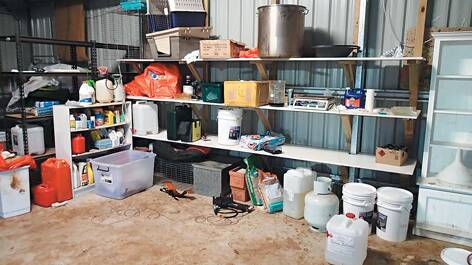 A police photo of the drug bust at Sun Valley, where they allegedly seized 1.5kg of MDA (a form of ecstasy) and more than 1000 litres of chemicals used in its manufacture.