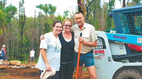 Foothills Vineyard Church members Rebekah Small and Malcolm Read with (centre) Lorraine West during the backyard blitz. "We wanted to show that people still cared," Mrs Small said.