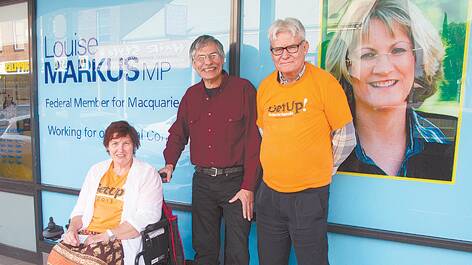GetUp members Lyn Trindall, Martin Wolterding and John Gale outside the office of Macquarie MP Louise Markus.