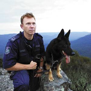“One of the strongest biters in the squad”: Senior Constable Luke Warburton and his Police Dog ‘Chuck’ who played his part in fugitive Malcolm Naden’s capture and arrest on March 22 by biting him on the leg. Photo: David Darcy.