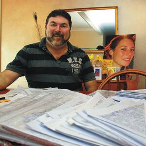 Show of support: Peter Frazer with some of the 15,000 signatures that have been receieved in support of the petition calling for new legislation following the death of his daughter Sarah (pictured in background).