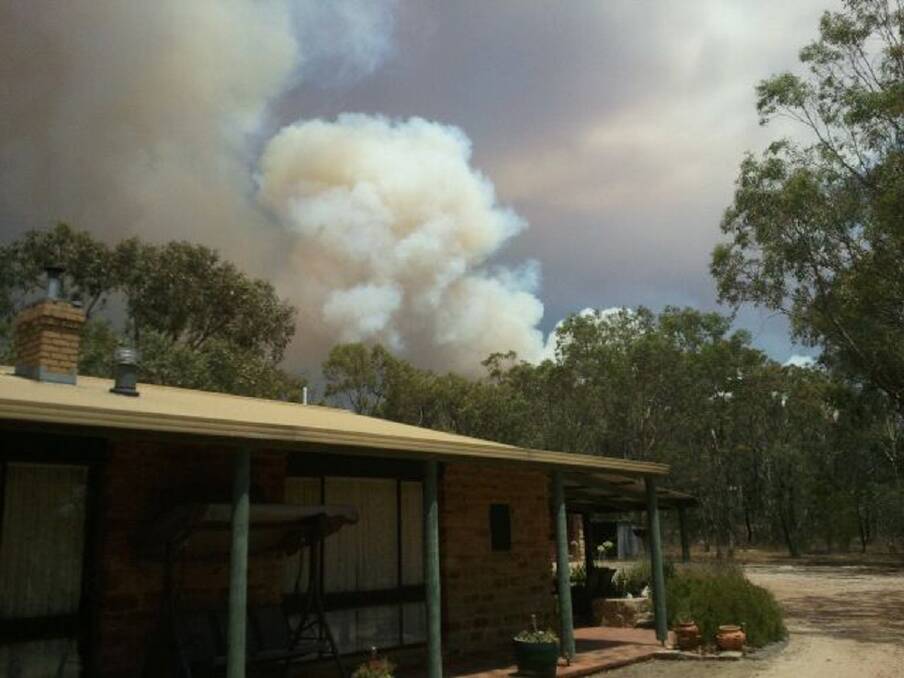 The smoke rises above Luke and Mel Healy's home in the Black Ranges as the fire becomes more intense, forcing them to evacuate.