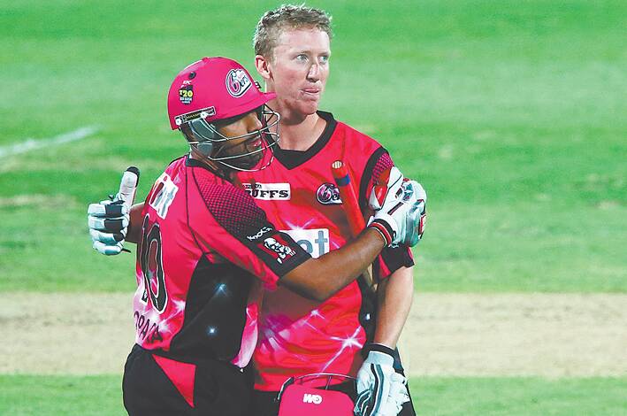 Jordan Silk (right) is congratulated by Ravi Bopara of the Sydney Sixers after taking victory during the Big Bash League match against the Adelaide Strikers at Adelaide Oval on January 5. Photo: Daniel Kalisz/Getty Images.