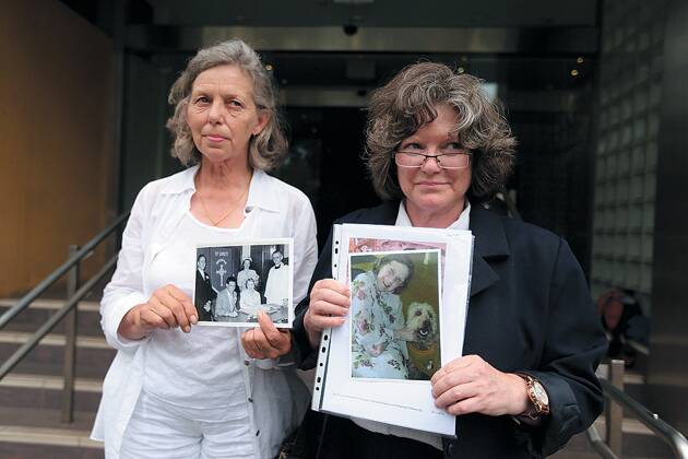 Adele Zimmerman and Michelle Zimmerman hold photos of their mother Sibyl Zimmerman, who died in a nursing home in 2011, outside the  NSW coroners court in Glebe on Monday. Photo: Kate Geraghty.