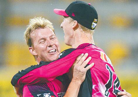 Brett Lee (left) and Jordan Silk of the Sixers celebrate after Jordan Silk takes a  spectacular catch to dismiss Craig Kieswetter of the Heat during the Big Bash League match between Brisbane Heat and the Sydney Sixers at The Gabba on January 2. Photo: Bradley Kanaris/Getty Images