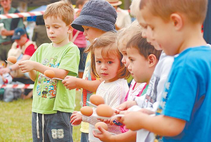 Youngsters prepare for an egg-and-spoon race.