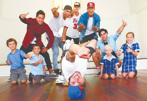 Justice Crew's Lukas Bellesini, front, with fellow band members, from left, John Pearce, Solo Tohi, Paulie Merciadez, Samson Smith and Lenny Pearce, celebrate their visit to Glenbrook’s St Finbar's Primary School with pupils, from left, Nicholas Casha, Cooper Monacco, Zoe McKenzie and Sarah Darby.