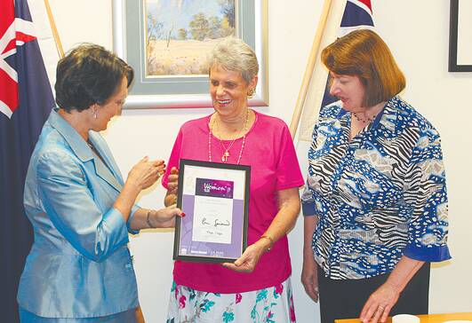 Minister for Family and Community Services, Pru Goward, presents the NSW local woman of the year award to Colleen Kime, watched by Blue Mountains MP Roza Sage.