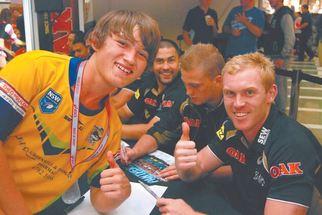 Panthers fan and U16s Katoomba Devils player Chase Hunter with Penrith's first grade half Peter Wallace at an autograph signing session at Penrith Westfield last Thursday night.