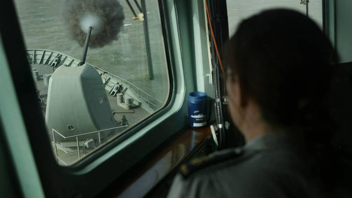 An Australian navy personel watches the guns fire towards Basra in Iraq, from the bridge of the HMAS ANZAC in the Northern Arabian Gulf. 22nd March 2003. Photo: Kate Geraghty